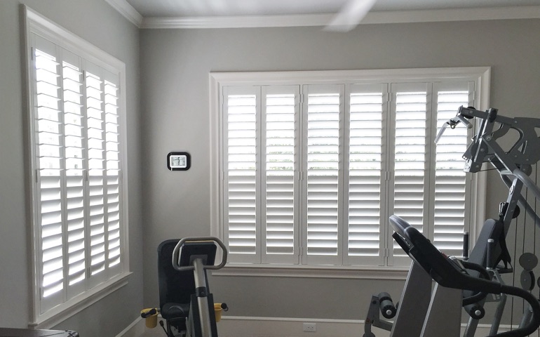 Bluff City home gym with shuttered windows.